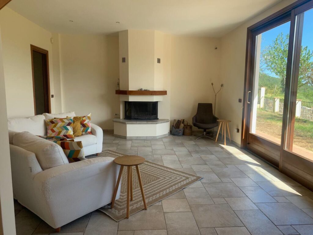 Living room with fireplace and doors to the patio