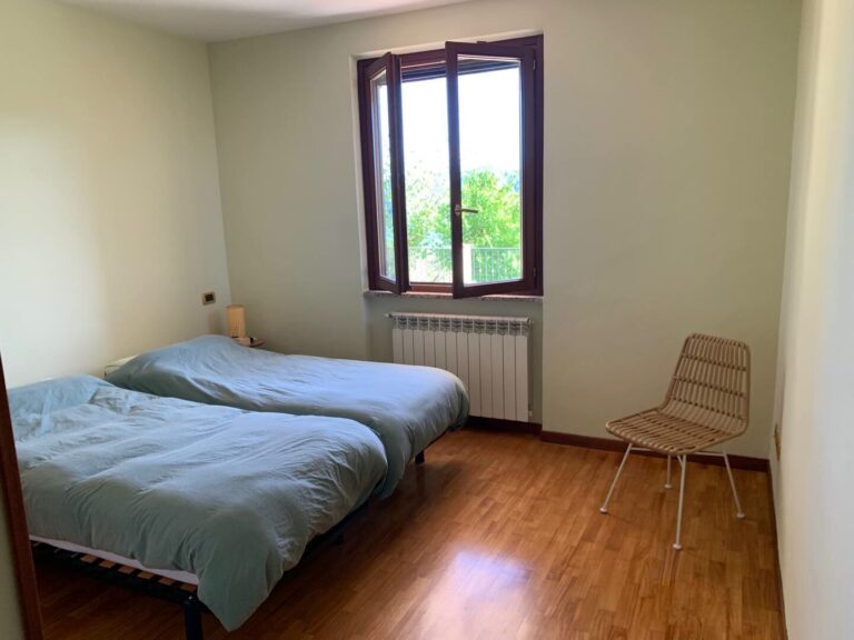 Bedroom with two single beds and wooden floor
