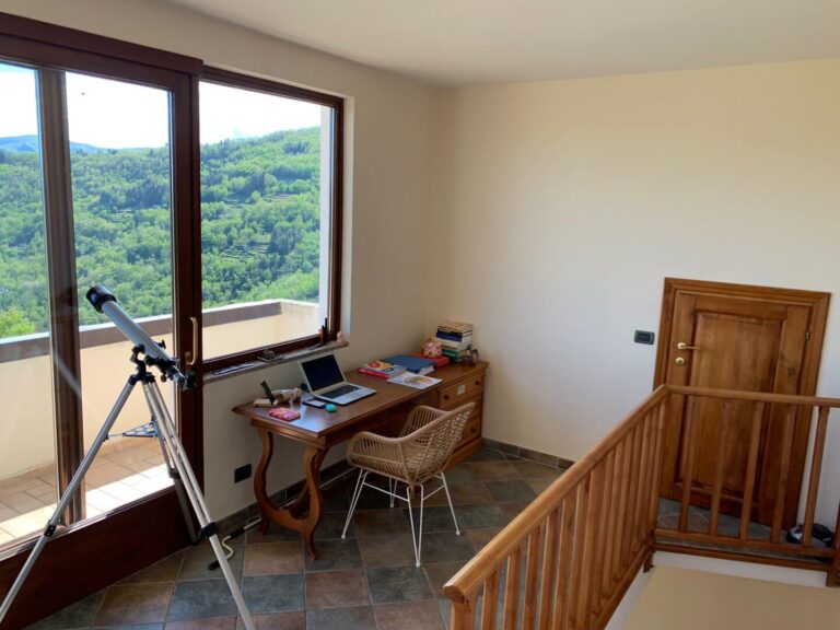 Upstairs living area with desk and telescope